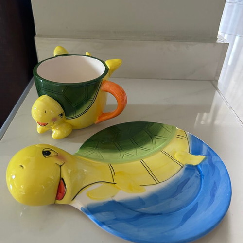 Vintage ceramic children's mug with turtle design used