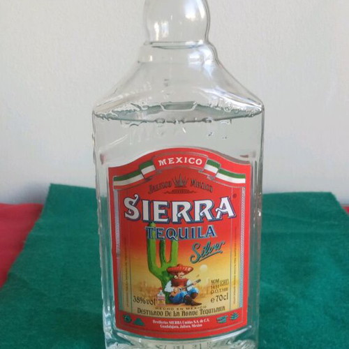 Sierra vintage tequila used, opened bottle with cap damage