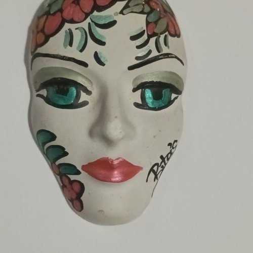 Handpainted handmade mask used with Rita's signature