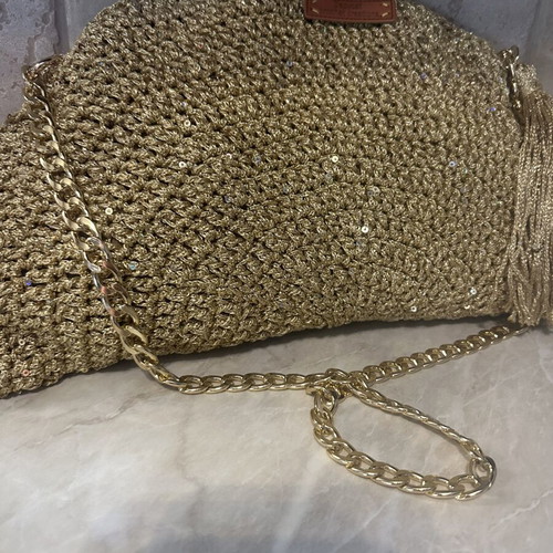 Handmade knitted shoulder bag in gold with decorative tassel
