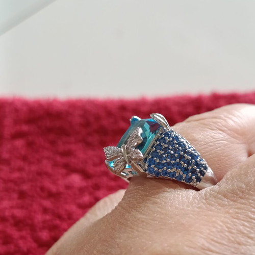 Women's ring new with emerald cut blue stone and butterfly detail