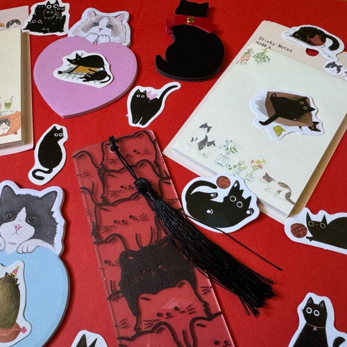 Cat-themed stationery set like new with sticky notes, pens, bookmarks, and stickers