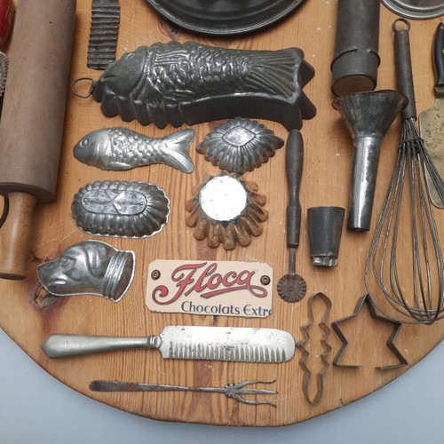 Collection of vintage pastry tools on wooden board