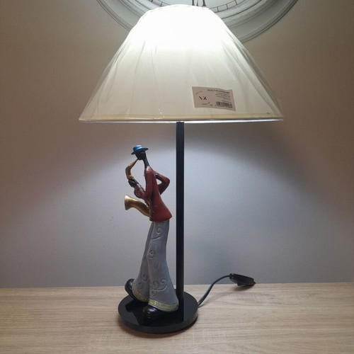 Table lamp with jazz player on plexiglass base and beige shade
