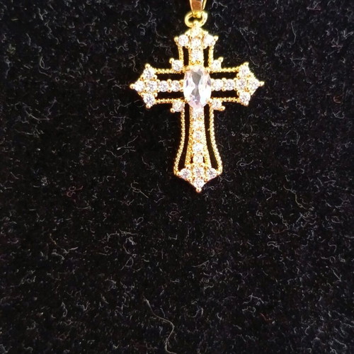 Women's cross new in gold color with white zircon stones