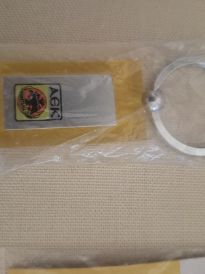 AEK pin and keychain new, authentic collectible