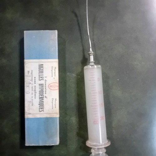 Antique glass syringe used with needle box
