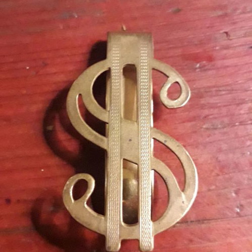Gold-plated money clip used with $ symbol