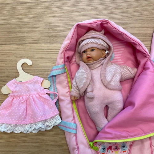 Baby doll like new vinyl with sleeping bag and knitted clothes