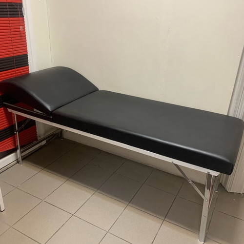 Examination bed used, black with inox folding legs