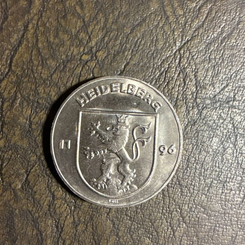 Collectible metal coin with embossed castle design, new