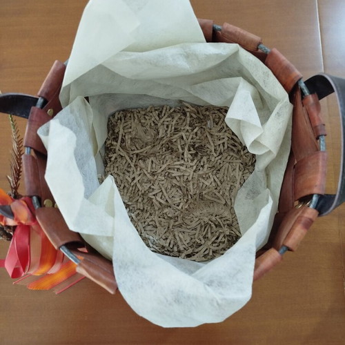 Wooden woven gift basket with leather handles, used
