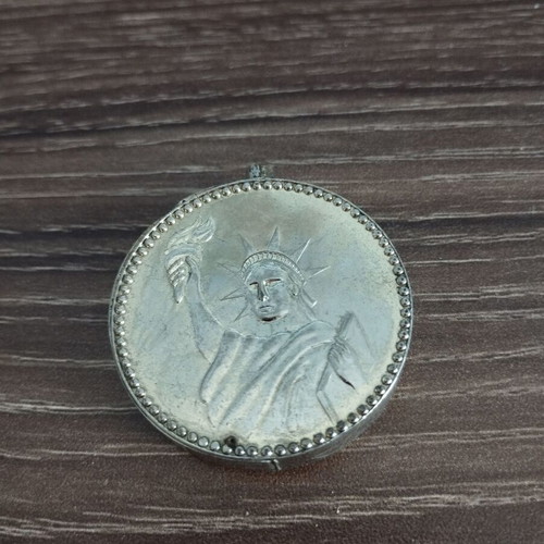 Collectible lighter used with John F. Kennedy and Statue of Liberty design