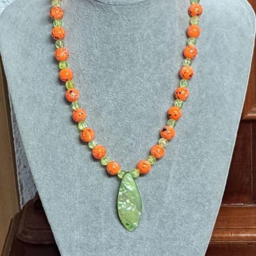 Long necklace with shell pendant, orange and green beads