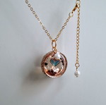 Handmade gold-colored necklace with pendant and pearl
