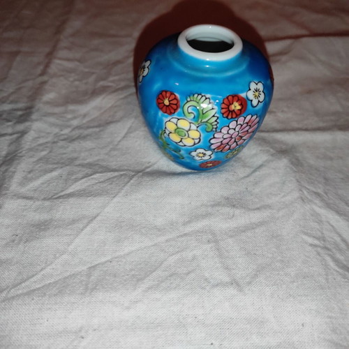 Small blue vase with porcelain flowers used