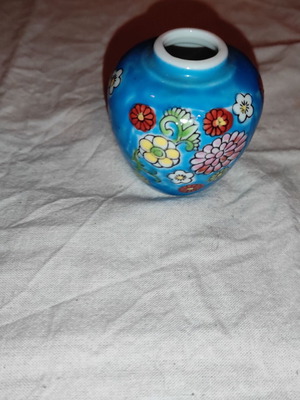 Small blue vase with porcelain flowers used
