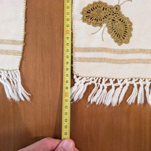 Set of three table linens with handmade golden knitted butterfly, used