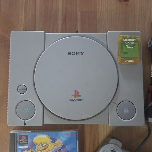 Sony PlayStation 1 console used with memory card, controller, and game