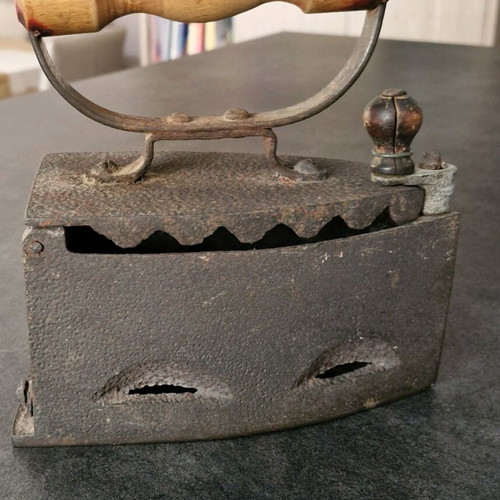 Vintage coal iron used with wooden handle and patina