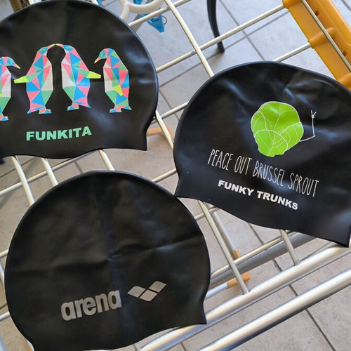 Three branded swimming caps