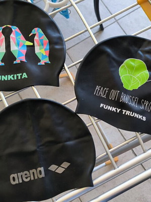 Three branded swimming caps