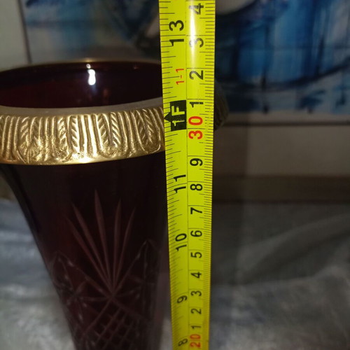 Vintage red glass vase with cut designs and decorative brass base and rim