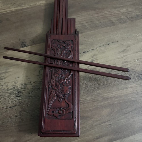 Japanese wooden box with 16 used chopsticks and palm carving