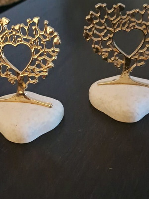 Decorative golden hearts on stone like new