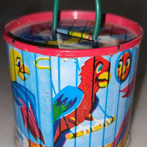 Vintage tin piggy bank used with parrots
