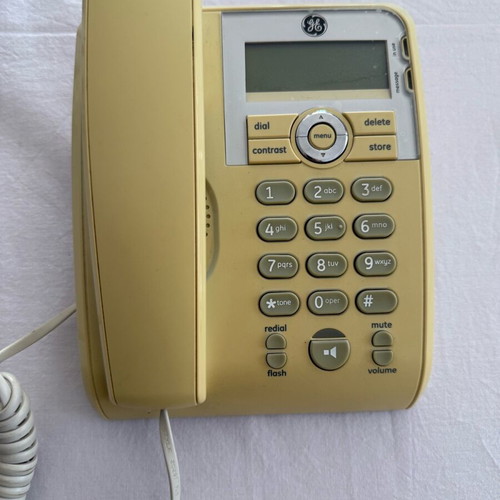 Corded phone with speakerphone used, white