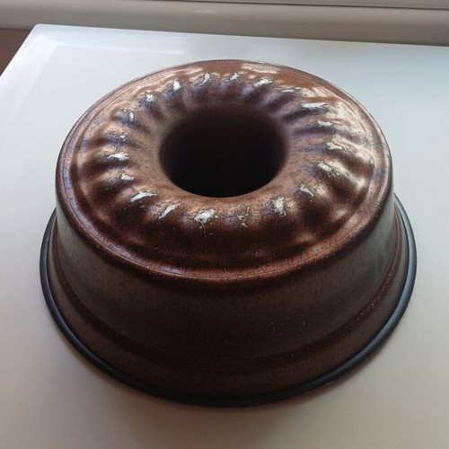 Large cake pan used with visible signs of wear