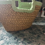 Straw handbag used with green details and flower decoration