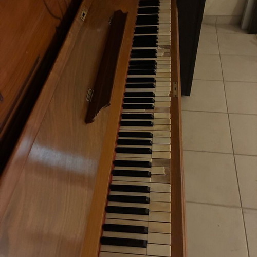 Wooden piano used, antique with key wear