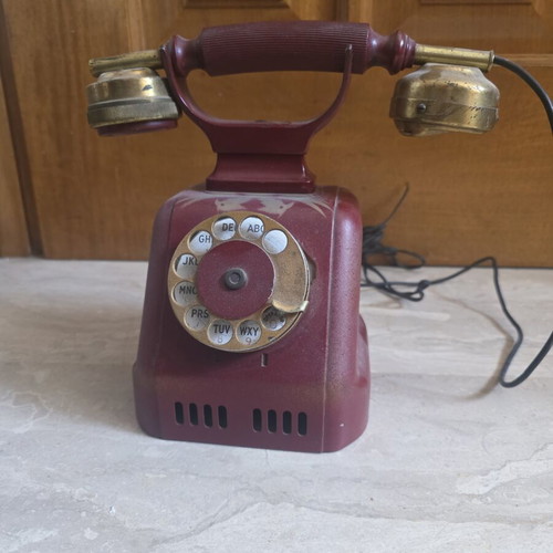 Metal telephone used, red, wired connection