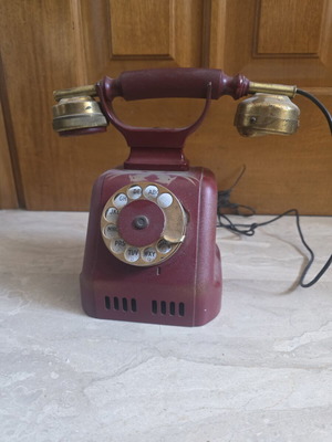 Metal telephone used, red, wired connection