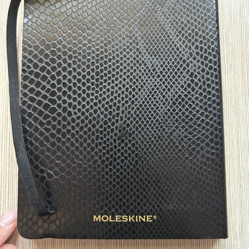 Moleskine black notebook with embossed cover