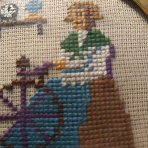Handmade framed embroidery used with cross-stitch and glass