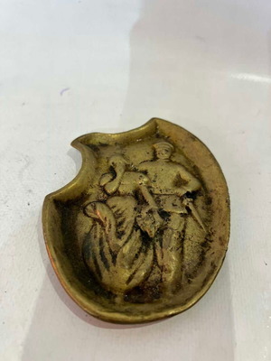 Vintage brass ashtray with embossed World War I scene used