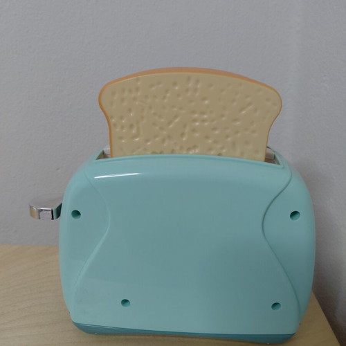Toy Toaster like new with realistic functions and two fake bread slices