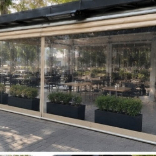 Vertical transparent PVC awnings used with mechanism for cafes and restaurants