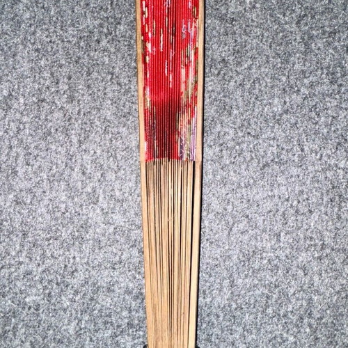 Wooden fan used, red with sakura blossoms