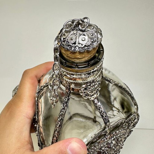 Vintage ornate handmade filigree glass bottle with red stones