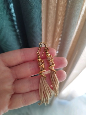 earrings with tassel and person