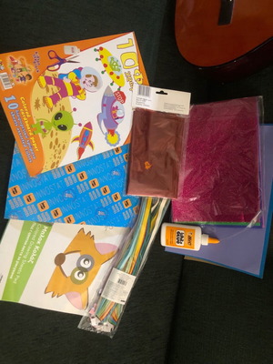 Craft supplies like new with colored sheets, red glitter foil, and UHU glue