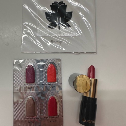Lancôme lipstick with samples and Diptyque fragrance sticker