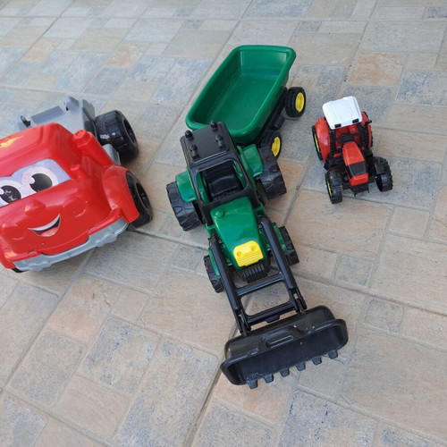Set of 3 children's plastic vehicles: green tractor with loader and trailer, red truck, small red and black tractor