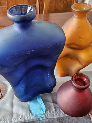 Three glass vases used, blue orange and red set