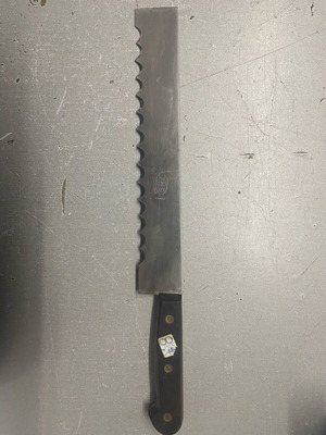 Bread knife with wooden handle like new, 24.5 cm blade length from France