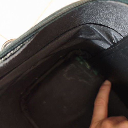 Toiletry bag used, green, fabric defect